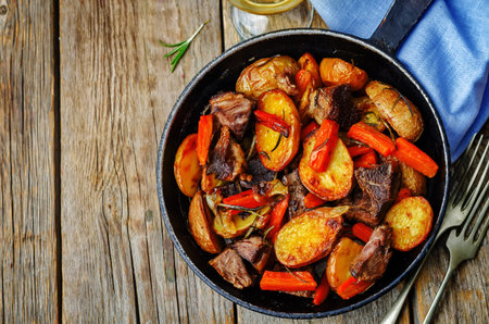 Meat roasted with potatoes, carrots, onions, rosemary and garlic. the toning. selective focusの写真素材