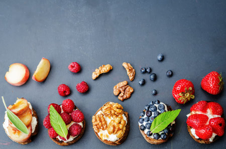 ricotta and crostini appetizers with fillings on a black backgroundの写真素材