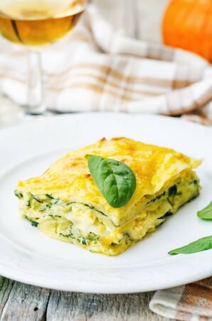 pumpkin ricotta spinach lasagna on a white wood background. the toning. selective focusの写真素材
