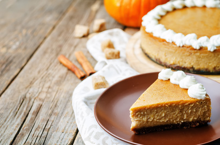 pumpkin cheesecake decorated with whipped cream. the toning. selective focusの写真素材