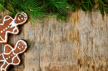 Christmas tree background with Christmas tree and gingerbread shaped cookies. the toning. selective...