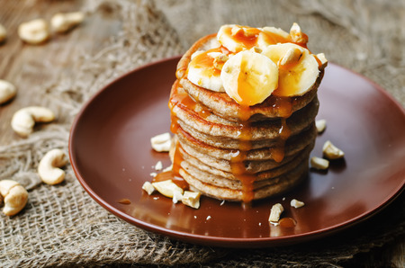 banana cashew pancakes with bananas and salted caramel sauce. the toning. selective focusの写真素材