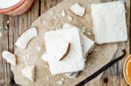 raw vegan coconut bars on a dark wood background. the toning. selective focusの写真素材