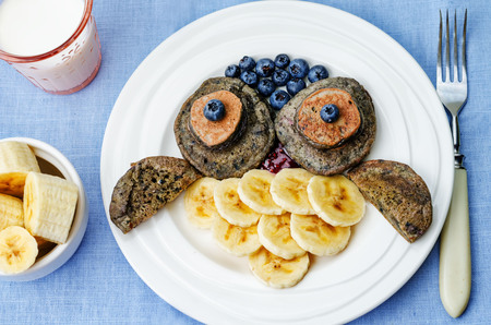 blueberry chocolate pancake with bananas in the shape of an owl for kids. toning. selective focusの写真素材