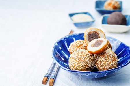 Chinese sesame balls with sweet red bean paste on a white background. toning. selective focusの写真素材