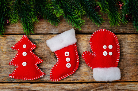 wood background with Christmas tree and homemade fleece toys. toning. selective focusの写真素材