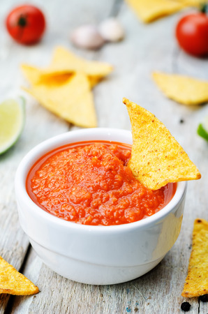 blended red salsa on the white wood background. toning. selective focusの写真素材