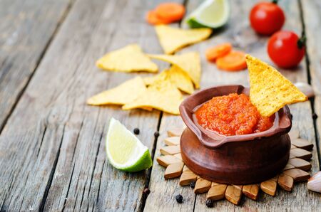 blended red salsa on the dark wood background. toning. selective focusの写真素材