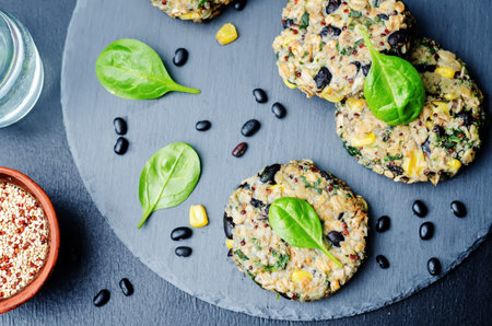 quinoa black bean spinach corn burgers on a black background. toning. selective Focusの写真素材