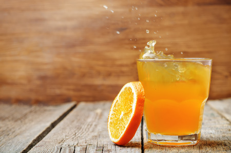 orange juice on a dark wood background. toning. selective Focusの写真素材