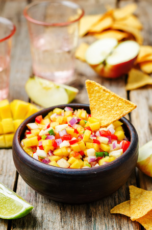 apple mango salsa on a dark wood background. toning. selective Focusの写真素材