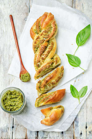 braided basil pesto bread on a white wood background. toning. selective Focusの写真素材