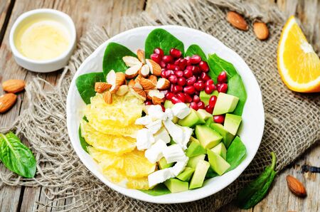 Spinach feta avocado pomegranate orange almond salad with orange vinegar dressing. toning. selective Focusの写真素材