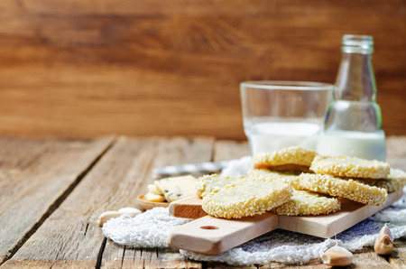 Garlic cheese, blue cheese crackers with sesame seeds on a dark wooden background. toning. selective Focusの写真素材