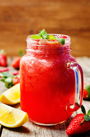 strawberry lemonade on a dark wooden background. toning. selective focusの写真素材