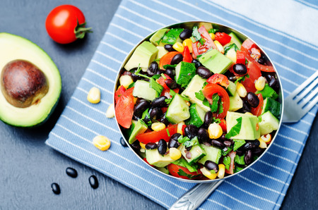 Black beans corn avocado cucumber tomato salad with lime dressing. toning. selective focusの写真素材