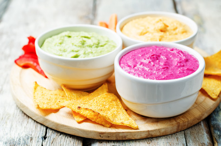 multicolored vegetables beans hummus with vegetables and chips. toning. selective focusの写真素材