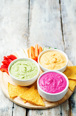 multicolored vegetables beans hummus with vegetables and chips. toning. selective focusの写真素材
