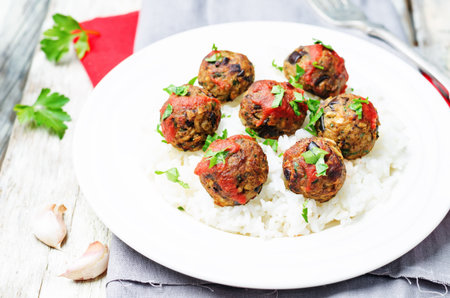 Eggplant white beans vegan meatballs with tomato sauce and rice. toning. selective focus