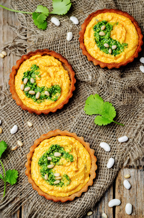 buckwheat tartlets with with white beans carrot hummus and cilantro pesto. toning. selective focusの写真素材