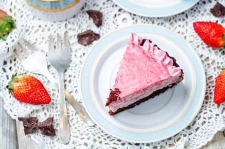 Strawberry mousse brownie cake on white wood background. toning. selective focus