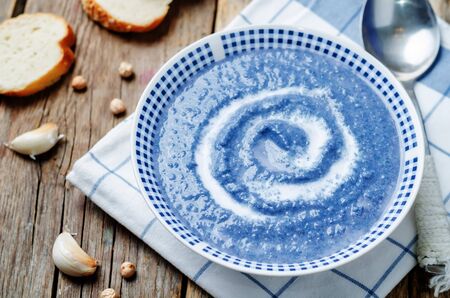 red cabbage chickpea soup puree on a dark wood background. toning. selective focusの写真素材