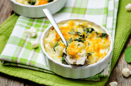 Chicken Spinach Cauliflower casserole on a dark wood background. toning. selective focusの写真素材