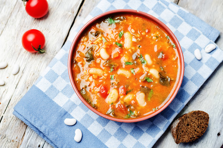 tomatoes spinach white beans millet soup. toning. selective focusの写真素材