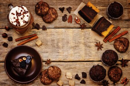 List of chocolate dishes. Cheesecake, muffins, cookies, pumpkin brownies, hot chocolate. toning. selective focusの写真素材