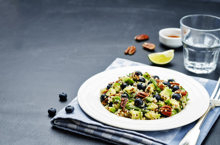 Quinoa avocado blueberry pecan salad with maple syrup lime dressing. toning. selective focusの写真素材