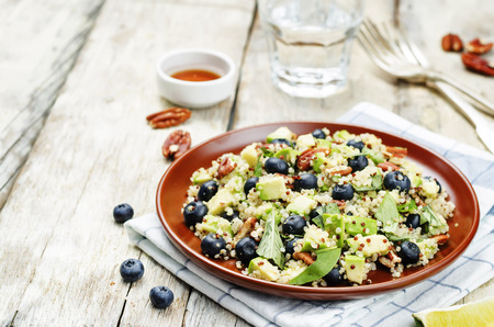 Quinoa avocado blueberry pecan salad with maple syrup lime dressing. toning. selective focusの写真素材