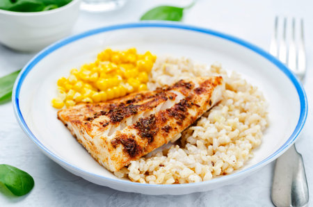 spices Cod with brown rice, spinach and corn. toning. selective focusの写真素材