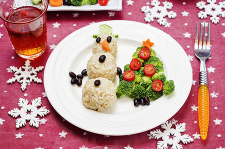 Christmas lunch with healthy kid's food in the form of a snowman and Christmas tree. toning. selective focusの写真素材