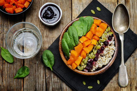 rice bowl with spinach, pumpkin, pumpkin seeds and cranberry sauce. toning. selective focusの写真素材