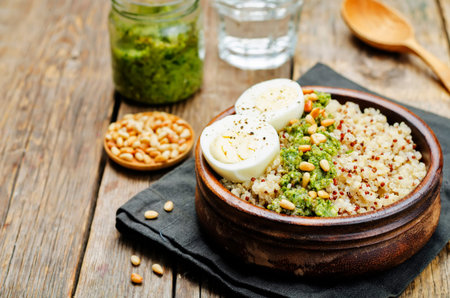 quinoa with kale pesto, pine nuts and eggs. toning. selective focusの写真素材