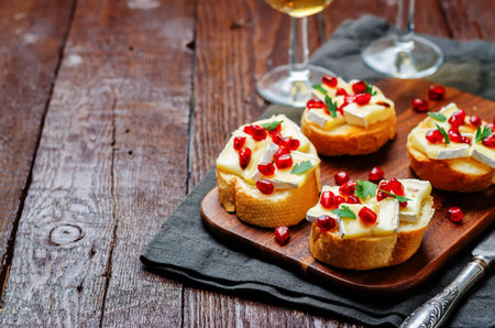 Brie pomegranate balsamic vinegar parsley crostini. toning. selective focusの写真素材