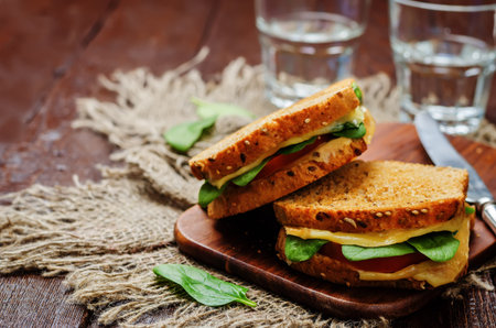 Spinach tomato cheese grilled rye sandwiches. toning. selective focusの写真素材