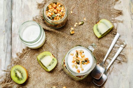Greek yogurt granola kiwi breakfast in jar. toning. selective focusの写真素材