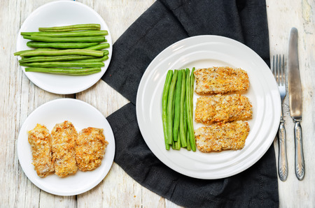 Bread crumbs cheese herbs baked cod with green beans. toning. selective focusの写真素材