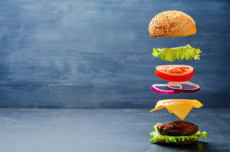 Flying burger on a dark background. toning. selective focusの写真素材