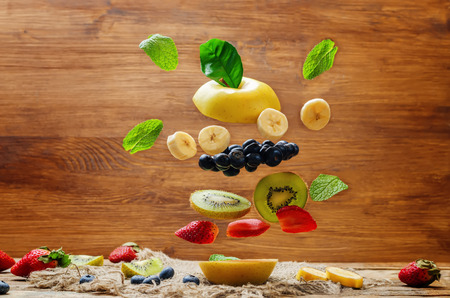 Flying fruit burger on wood background. toning. selective focusの写真素材