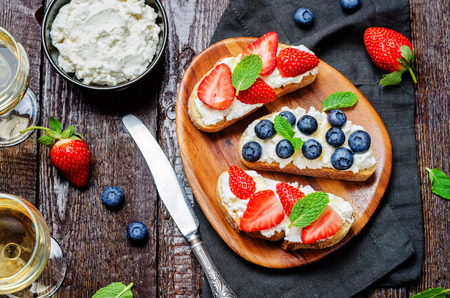 Strawberry and blueberry ricotta sandwiches. toning. selective focusの写真素材