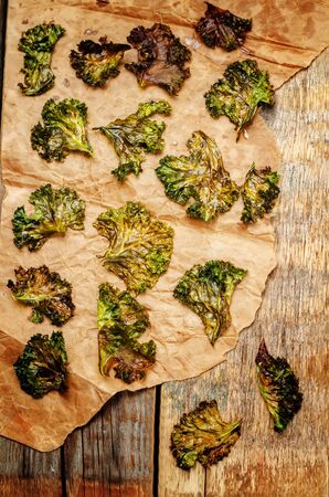 Kale chips on wood background. toning. selective focusの写真素材