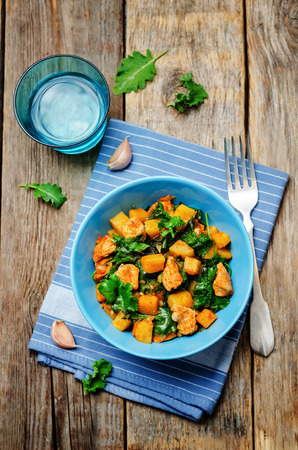 Kale sweet potato chicken stew on a wood background. toning. selective focusの写真素材