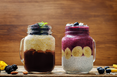 Blueberry banana greek yogurt and chocolate banana mango smoothies in jars. toning. selective focusの写真素材