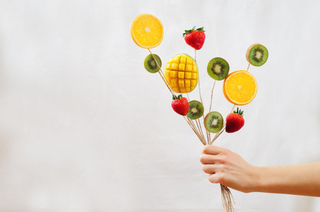 Fruit bouquet in a female hand. toning. selective focusの写真素材