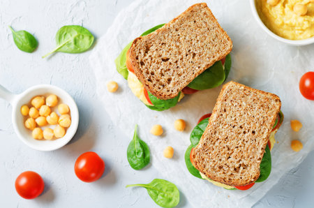 rye sandwiches with hummus, spinch and tomatoes. toning. selective focusの写真素材