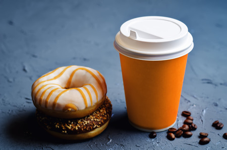 Donuts with coffee on a dark stone background. toning. selective focus の写真素材