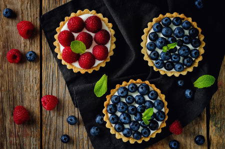 Raspberry and blueberry tartlets. toning. selective focusの写真素材