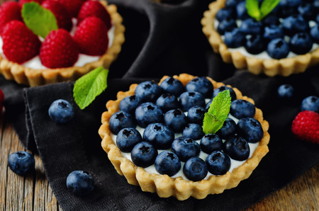 Raspberry and blueberry tartlets. toning. selective focusの写真素材